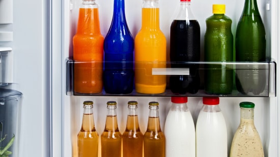 Variety of Beverage Bottles in a Refrigerator