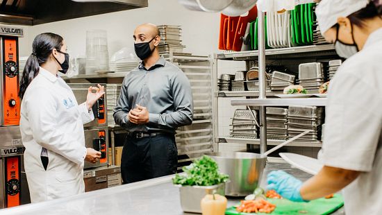 An Ecolab associate speaking with the manager of a customer kitchen.