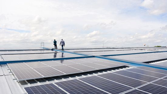 Two people walking on solar panels